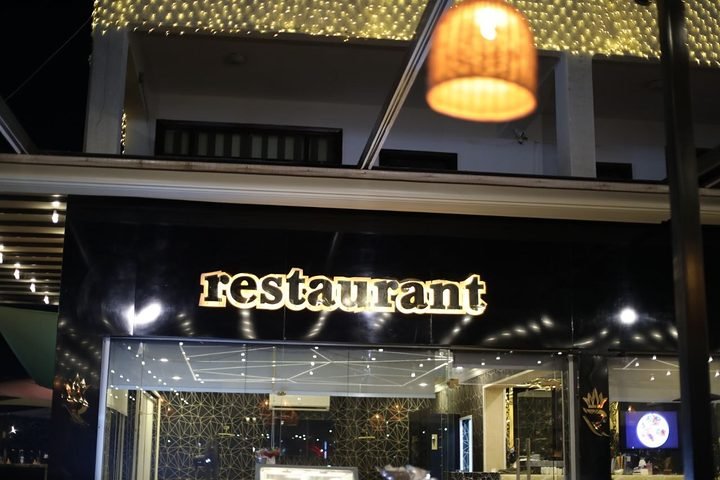 The Richy restaurant sign lit up at night