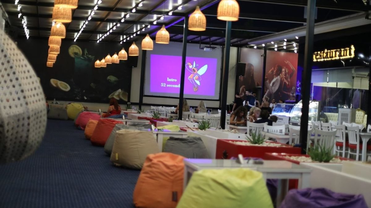 The Richy Lounge garden terrace with colourful beanbags and woven lamps