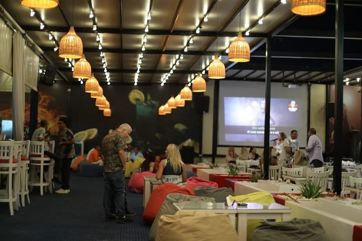 The terrace with the karaoke screen and woven lamps